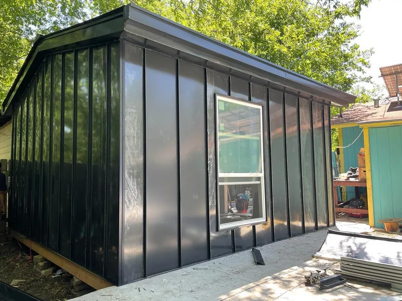 Black standing seam metal wall panels for Roof Inspection in St. Gabriel