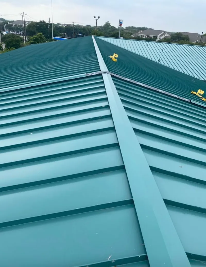 Green commercial metal roof ridge and valley for Metal Roof Repair in St. Gabriel
